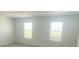 Bright bedroom with two windows at 5067 Northern Dove Ave, Mount Dora, FL 32757