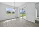 Eat-in dining room featuring wood-look tile floor and sliding glass door leading to back patio at 5067 Northern Dove Ave, Mount Dora, FL 32757