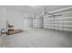 Spacious three car garage featuring concrete flooring and two garage doors at 5067 Northern Dove Ave, Mount Dora, FL 32757