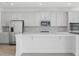 Bright kitchen with stainless steel appliances, an island, and ample cabinet space at 5067 Northern Dove Ave, Mount Dora, FL 32757