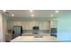Modern kitchen with stainless steel appliances and a large center island at 5067 Northern Dove Ave, Mount Dora, FL 32757