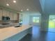 Bright kitchen with a center island flowing into the living room at 5067 Northern Dove Ave, Mount Dora, FL 32757