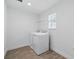 Functional laundry room with modern appliances, a window for natural light, and tile flooring at 5067 Northern Dove Ave, Mount Dora, FL 32757