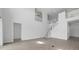 Spacious living room featuring wood-look tile floor, stairway, and lots of natural light at 5067 Northern Dove Ave, Mount Dora, FL 32757