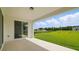 Outdoor patio with a beautiful view of the green lawn and trees at 5067 Northern Dove Ave, Mount Dora, FL 32757