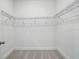 Spacious walk-in closet with metal shelving and plush carpeting at 5067 Northern Dove Ave, Mount Dora, FL 32757