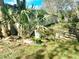 Slightly overgrown backyard with visible mobile home in background at 5149 Bryant Ave, Sanford, FL 32773