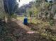 The backyard has lush greenery and a water filtration tank system at 5149 Bryant Ave, Sanford, FL 32773