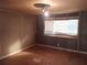 A bedroom with paneled walls, wood floors, and a window at 5149 Bryant Ave, Sanford, FL 32773
