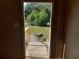 View from inside showing wood floors, short stairs with handrails, and a view of the yard through the front door at 5149 Bryant Ave, Sanford, FL 32773