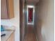 A long, narrow hallway with doors leading to various rooms. The floors are wood and the walls are paneled at 5149 Bryant Ave, Sanford, FL 32773