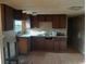 The kitchen features dated cabinets, laminate countertops, a window over the sink, and a wood-look floor at 5149 Bryant Ave, Sanford, FL 32773