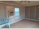 This living room features paneled walls, wood-look flooring, a ceiling fan, two windows, and a wall AC unit at 5149 Bryant Ave, Sanford, FL 32773