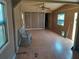A spacious living room with paneled walls, wood-look flooring, a ceiling fan, and two windows at 5149 Bryant Ave, Sanford, FL 32773