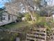 Overgrown side yard with mobile home in background at 5149 Bryant Ave, Sanford, FL 32773