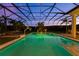 Expansive pool and patio at dusk, with a basketball hoop and ping pong at 5310 Tildens Grove Blvd, Windermere, FL 34786