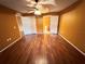 Main bedroom with laminate floors, ceiling fan, and en-suite bathroom at 553 Vista Way Ln Ln, Eagle Lake, FL 33839