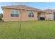 Home's backyard features a covered patio and a grassy lawn at 603 Lazio Cir, Debary, FL 32713