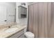 Clean bathroom with granite countertop, shower, and storage cabinet at 603 Lazio Cir, Debary, FL 32713