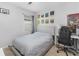 Well-lit bedroom featuring a queen bed, a workspace, and artwork at 603 Lazio Cir, Debary, FL 32713