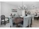 Open dining room with dark wood table, gray chairs, and kitchen views at 603 Lazio Cir, Debary, FL 32713