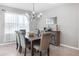 Formal dining room with a dark wood table and gray upholstered chairs at 603 Lazio Cir, Debary, FL 32713