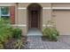 Front entry with a paved walkway, landscaping, and a brown door at 603 Lazio Cir, Debary, FL 32713
