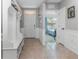 Bright and airy foyer with a white bench and view to a bedroom at 603 Lazio Cir, Debary, FL 32713