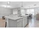 Open concept kitchen with island, granite countertops, and views to living room at 603 Lazio Cir, Debary, FL 32713
