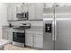 Modern kitchen featuring stainless steel appliances and granite countertops at 603 Lazio Cir, Debary, FL 32713