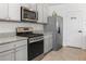 Kitchen with stainless steel appliances, granite countertops, and a pantry at 603 Lazio Cir, Debary, FL 32713