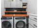 Laundry room with washer, dryer, and ample cabinets for storage at 603 Lazio Cir, Debary, FL 32713