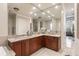 Elegant bathroom with double vanity, granite countertop, and large mirror at 6220 Cartmel Ln, Windermere, FL 34786