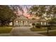 Beautiful two-story home with a brick driveway and manicured lawn at 6220 Cartmel Ln, Windermere, FL 34786