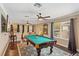 Game room with pool table, large TV, and comfortable seating area at 6220 Cartmel Ln, Windermere, FL 34786
