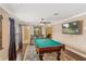Game room with pool table, TV, hardwood floors, and access to a bathroom at 6220 Cartmel Ln, Windermere, FL 34786