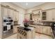 Island kitchen with granite countertops, custom cabinetry, and high-end appliances at 6220 Cartmel Ln, Windermere, FL 34786