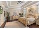 Main bedroom with a post bed and tray ceiling at 6220 Cartmel Ln, Windermere, FL 34786