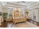Main bedroom with a post bed and access to balcony at 6220 Cartmel Ln, Windermere, FL 34786