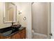 Modern powder room with vessel sink and dark countertop at 6220 Cartmel Ln, Windermere, FL 34786