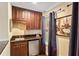 Wet bar with dark wood cabinets and granite countertop at 6220 Cartmel Ln, Windermere, FL 34786