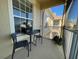 Private balcony with table and chairs, overlooks community at 6451 Old Park Ln # 404, Orlando, FL 32835