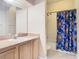 Clean bathroom with shower/tub combo, vanity, and a blue shower curtain at 6808 Cherry Grove Cir, Orlando, FL 32809