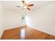 Well-lit bedroom featuring wood floors and a window at 749 Silver Birch Pl, Longwood, FL 32750