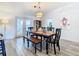 Bright dining room with wood table and chairs, and access to backyard at 7779 Murcott Cir, Orlando, FL 32835