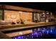 Inviting pool area with outdoor kitchen and seating at night at 8968 Bay Cove Ct, Orlando, FL 32819