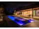 Stunning pool and spa at night with modern landscape at 8968 Bay Cove Ct, Orlando, FL 32819