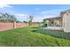 Green grassy backyard, brick wall, and screened porch at 10828 Cherry Oak Cir, Orlando, FL 32817