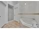 Bathroom featuring a corner bathtub and shower at 10828 Cherry Oak Cir, Orlando, FL 32817