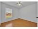 Bedroom featuring wood floors and a window at 10828 Cherry Oak Cir, Orlando, FL 32817